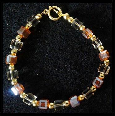 Auburn and Champaign Glass bracelet with Gold plated toggle clasp.
